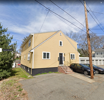 Marblehead apartment for rent - a yellow house with a car parked in front of it