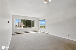 Anchorage apartment for rent - A spacious room with a large window overlooking a residential area.