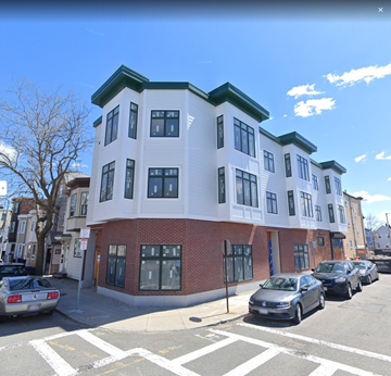 East Boston apartment for rent - a white and red building on a city street with cars