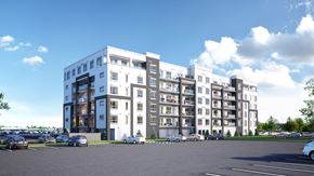 Winnipeg apartment for rent - A large white building with a parking lot in front of it.