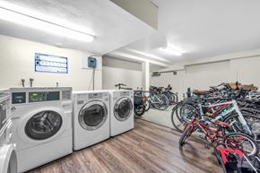 Vancouver apartment for rent - A laundry room with washers and dryers and bicycles in the background.