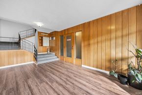 Vancouver apartment for rent - A room with wooden walls and a staircase.