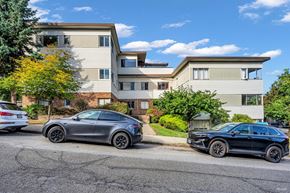Vancouver apartment for rent - Two cars parked in front of a two-story apartment building.