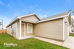 San Antonio house for rent - A house with a brown siding and a white door is for sale.