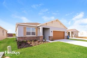 Bartow house for rent - A house with a garage and a driveway is shown in the image.
