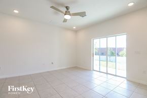 Bartow house for rent - A spacious room with a ceiling fan and sliding glass doors leading to a patio.