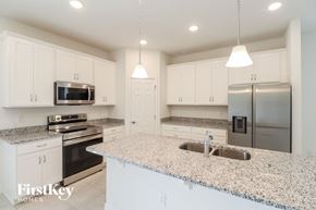 Bartow house for rent - A kitchen with granite countertops and stainless steel appliances.