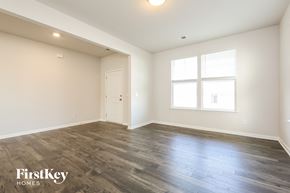 Greer house for rent - A spacious room with wooden flooring and a window.