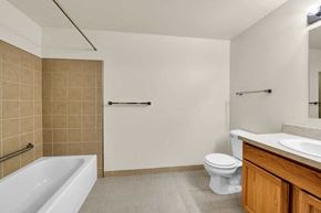 Utica apartment for rent - a bathroom with a toilet and a sink and a bath tub