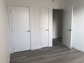 Vancouver apartment for rent - a row of white doors in a room with wood floors
