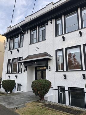 Vancouver apartment for rent - a white building with black windows and a black door