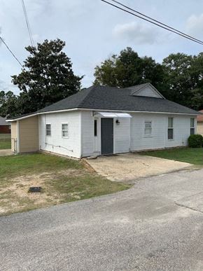 Hope Mills house for rent - A small white house with a grey roof and a grey door.