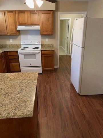 Hope Mills house for rent - A kitchen with a white stove and a white refrigerator.
