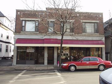 Chelsea apartment for rent - a red car parked in front of a store on a city street