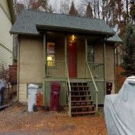 Pullman apartment for rent - A small house with a red door and a green staircase.