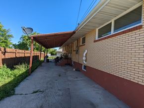 Great Falls apartment for rent - the side of a brick building with a covered walkway