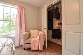 Columbia apartment for rent - a bedroom with a bed and a closet with a chair