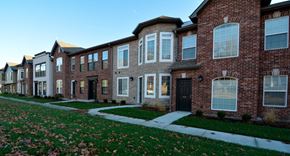 Columbia apartment for rent - a row of brick houses with sidewalk and grass