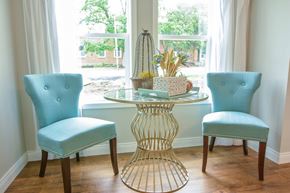 Columbia apartment for rent - a dining room table with two blue chairs and a window