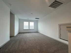 Rosharon house for rent - A spacious room with carpeted floor and a window with blinds.