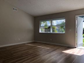 Port St. Lucie house for rent - A room with wooden flooring and a window with blinds.