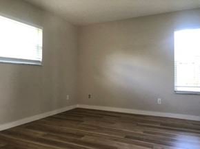 Port St. Lucie house for rent - A room with wooden flooring and two windows.