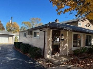 Hometown house for rent - a white house with a black roof and a driveway