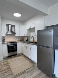 Nanaimo apartment for rent - A modern kitchen with a refrigerator on the right.