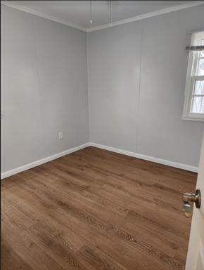 Hampton house for rent - a room with a wooden floor and white walls