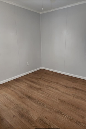 Hampton house for rent - an empty room with wooden floors and white walls