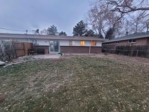Wheat Ridge house for rent - a house with a yard and a fence in front of it