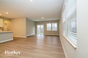 Danville house for rent - A spacious room with wooden flooring and a window with blinds.