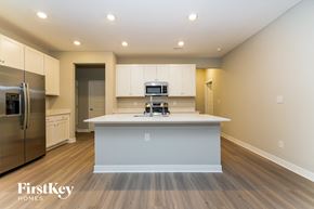 Danville house for rent - A kitchen with a refrigerator, microwave, and oven.