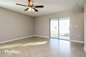 Davenport house for rent - an empty living room with a ceiling fan and a sliding glass door