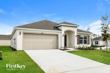 Davenport house for rent - a white house with a garage door and a driveway