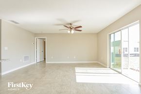 Davenport house for rent - A spacious room with a ceiling fan and a sliding glass door.