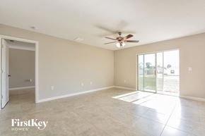Davenport house for rent - A spacious room with a ceiling fan and sliding glass doors.
