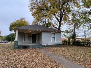 Tulsa house for rent - a small gray house with a sidewalk and trees