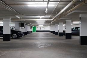 Toronto apartment for rent - A parking garage with a black car parked on the left side.