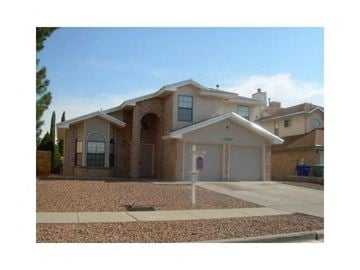 El Paso house for rent - A house with a brown roof and a grey garage door.