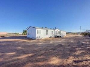 El Paso house for rent - a trailer is parked in the middle of a dirt field