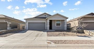 El Paso house for rent - a house with a driveway and a garage door
