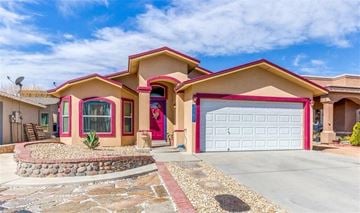 El Paso house for rent - a house with a garage door and a driveway