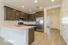 Litchfield Park house for rent - a kitchen with a large island and stainless steel refrigerator
