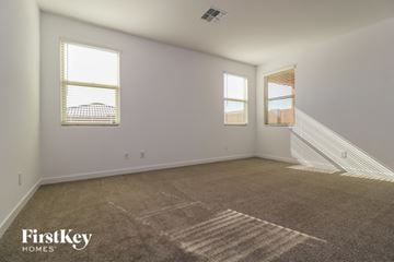 Litchfield Park house for rent - a spacious living room with carpet and two windows