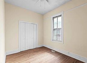 Portsmouth apartment for rent - an empty room with wooden floors and a white door and a window