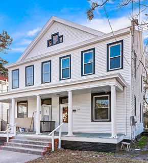 Portsmouth apartment for rent - A white house with a porch and a small front yard.