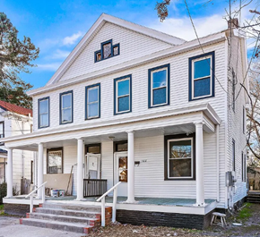 Portsmouth apartment for rent - A white house with a porch and a sign that reads 1828.