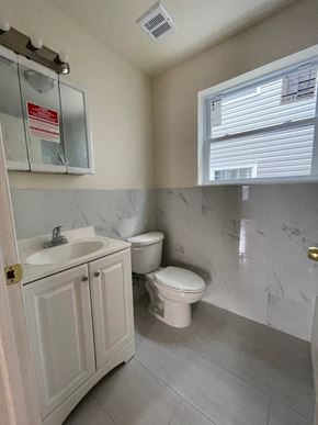 Newark apartment for rent - a bathroom with a toilet and a sink and a window