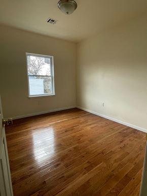 Newark apartment for rent - an empty room with wooden floors and a window